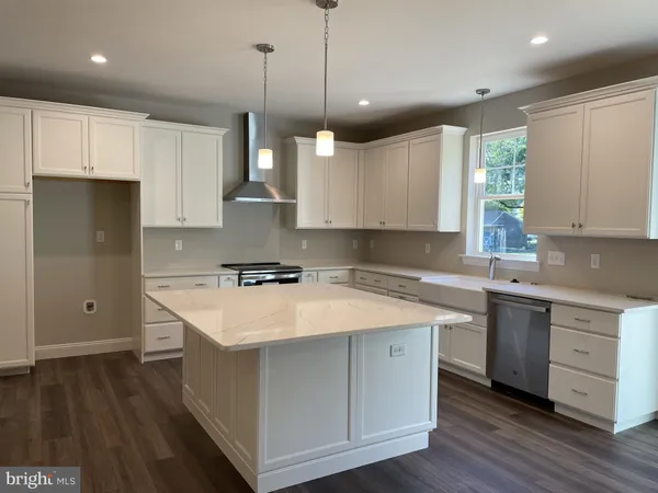 a kitchen with a sink window and cabinets