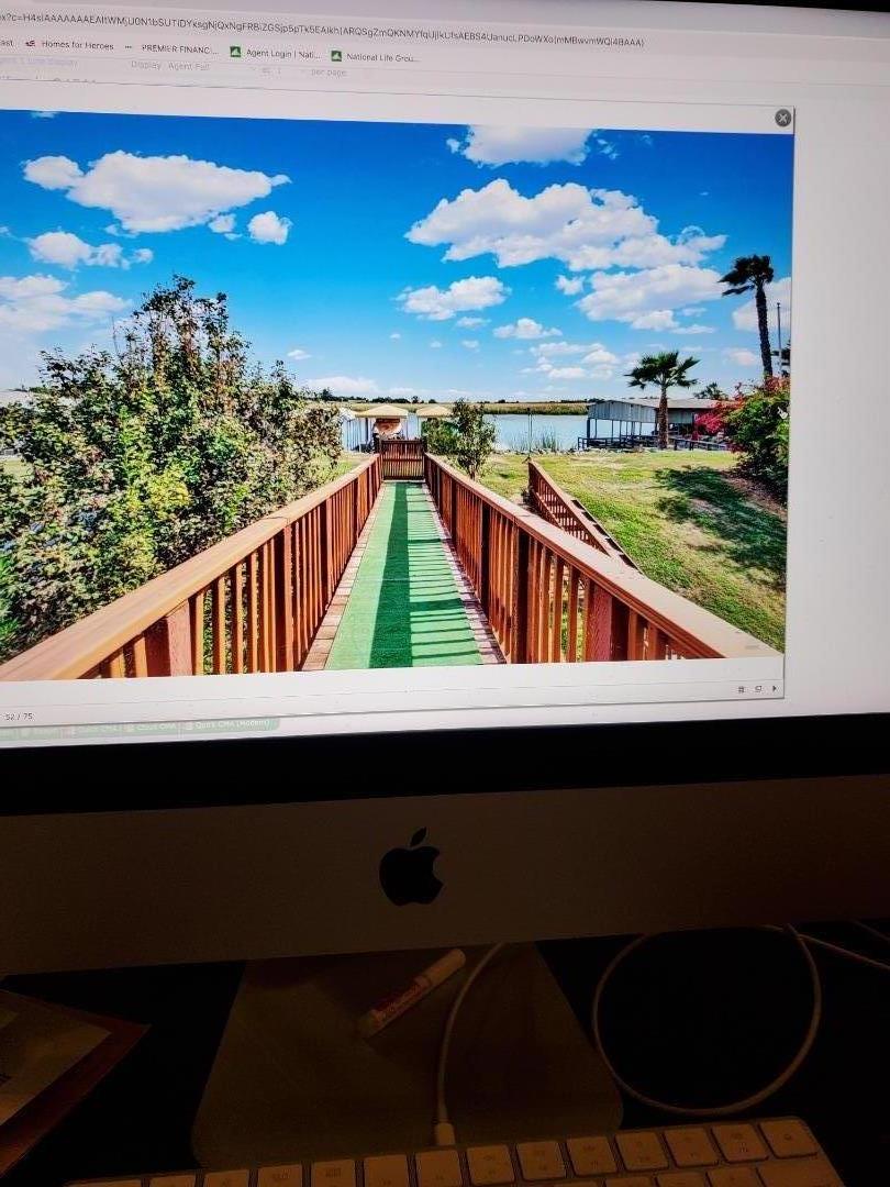 a view of a balcony with chair and wooden floor