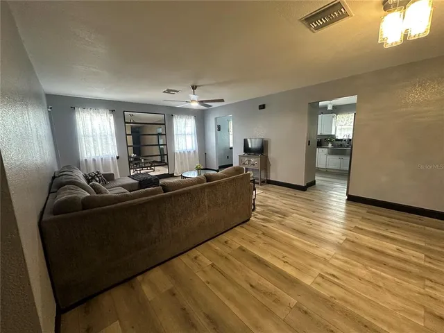 a bedroom with a large bed and a chandelier