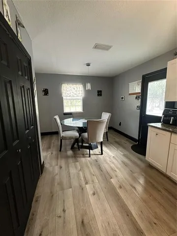 a kitchen with stainless steel appliances kitchen island granite countertop a refrigerator stove and sink