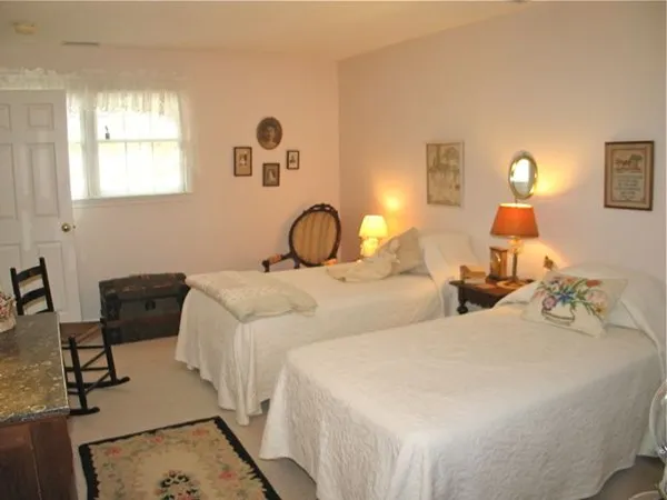 a bedroom with two beds and a dresser