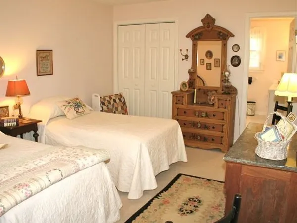 a bedroom with bed and cabinets