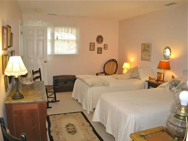 a bedroom with a bed and a dresser in it