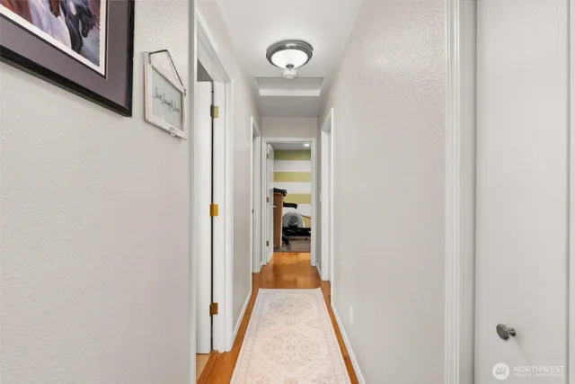 a view of a hallway with wooden floor and a hallway