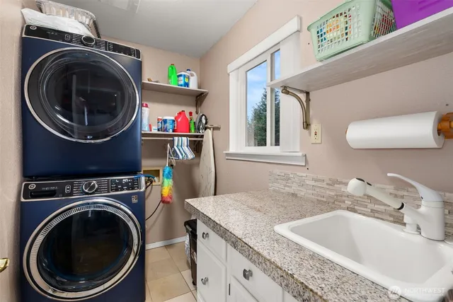 a bathroom with a sink a washer and dryer
