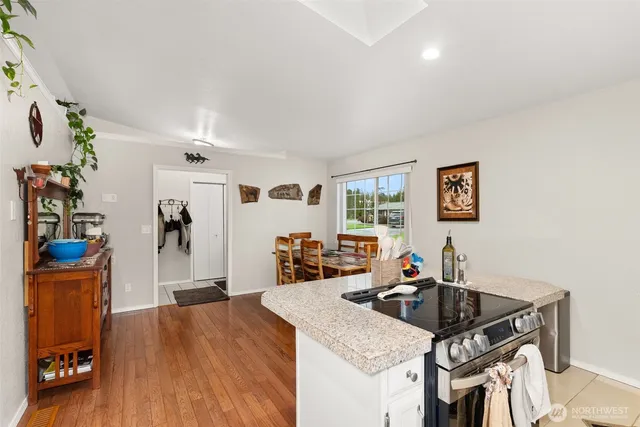 a view of a dining room with furniture and wooden floor