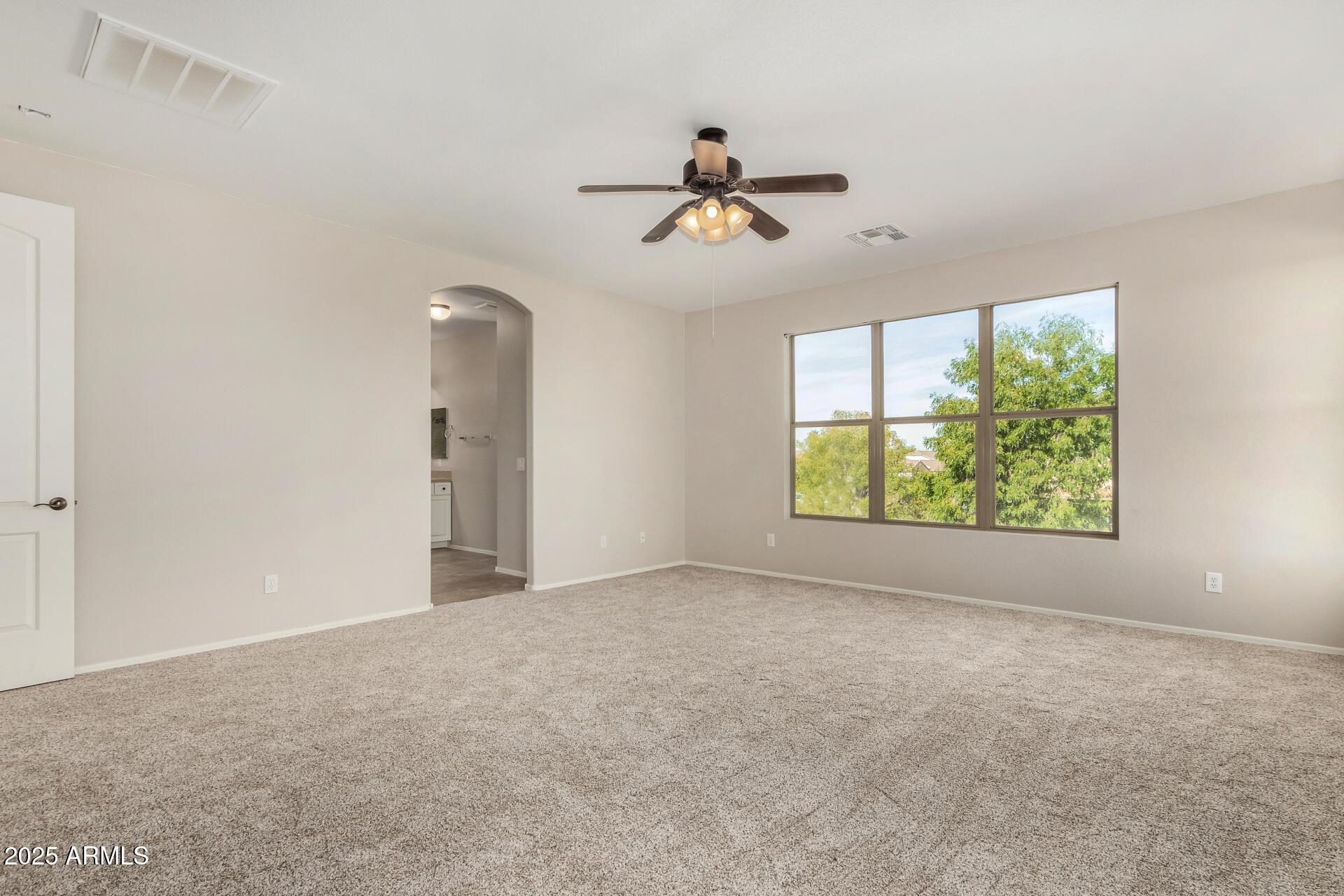 1036 East Oak Road San Tan Valley, AZ 85140 - Photo 14 of 37 a view of empty room with window and ceiling fan