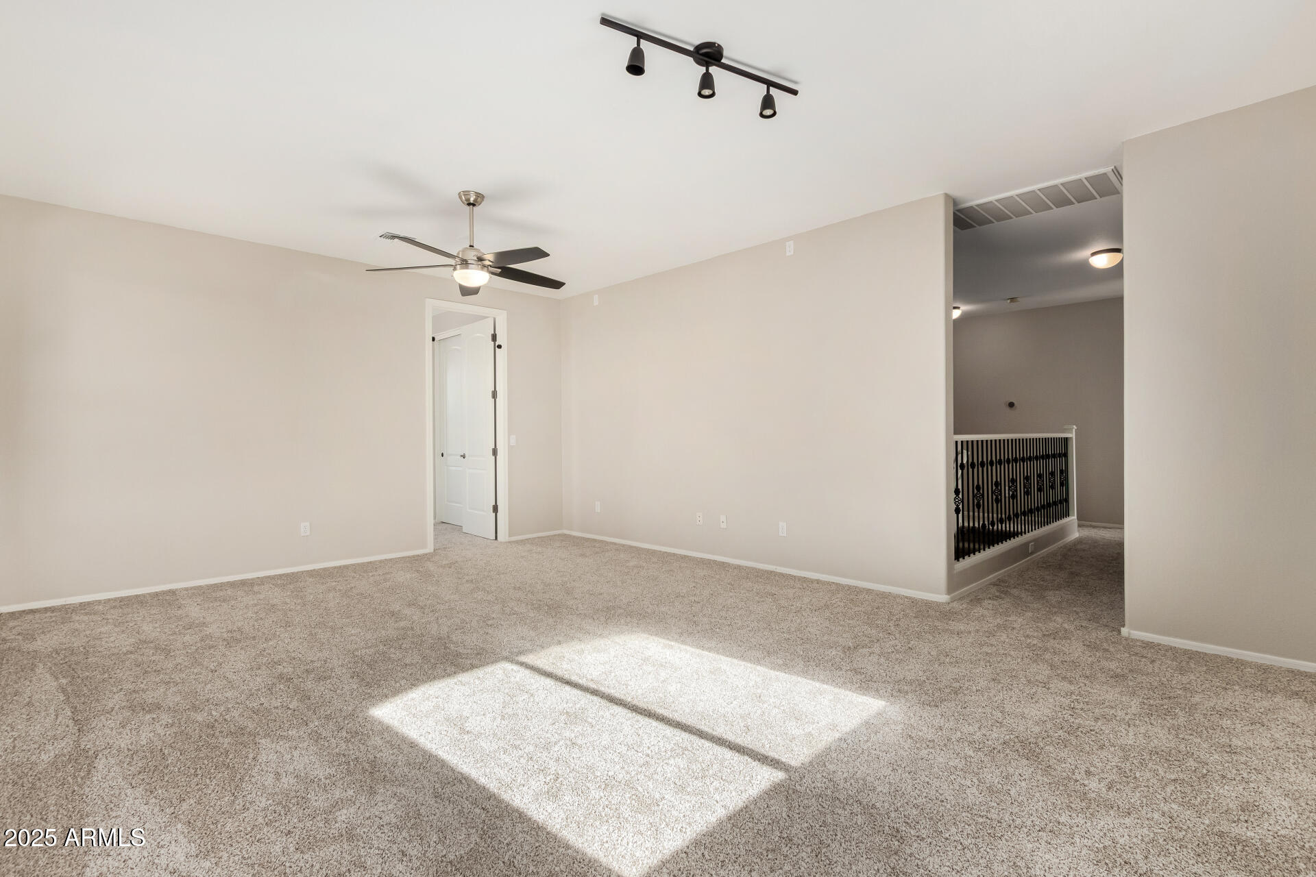 1036 East Oak Road San Tan Valley, AZ 85140 - Photo 25 of 37 an empty room with a ceiling fan and a window