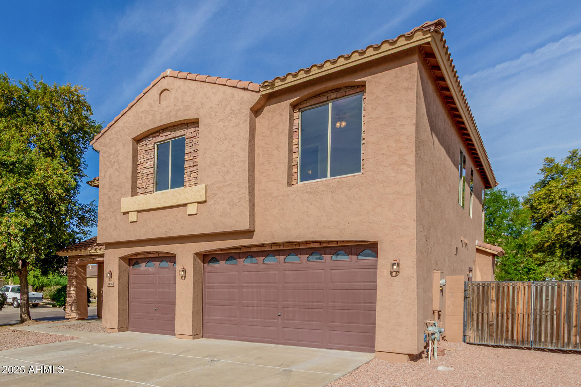 1036 East Oak Road San Tan Valley, AZ 85140 - Photo 8 of 37 a front view of a house with a garage