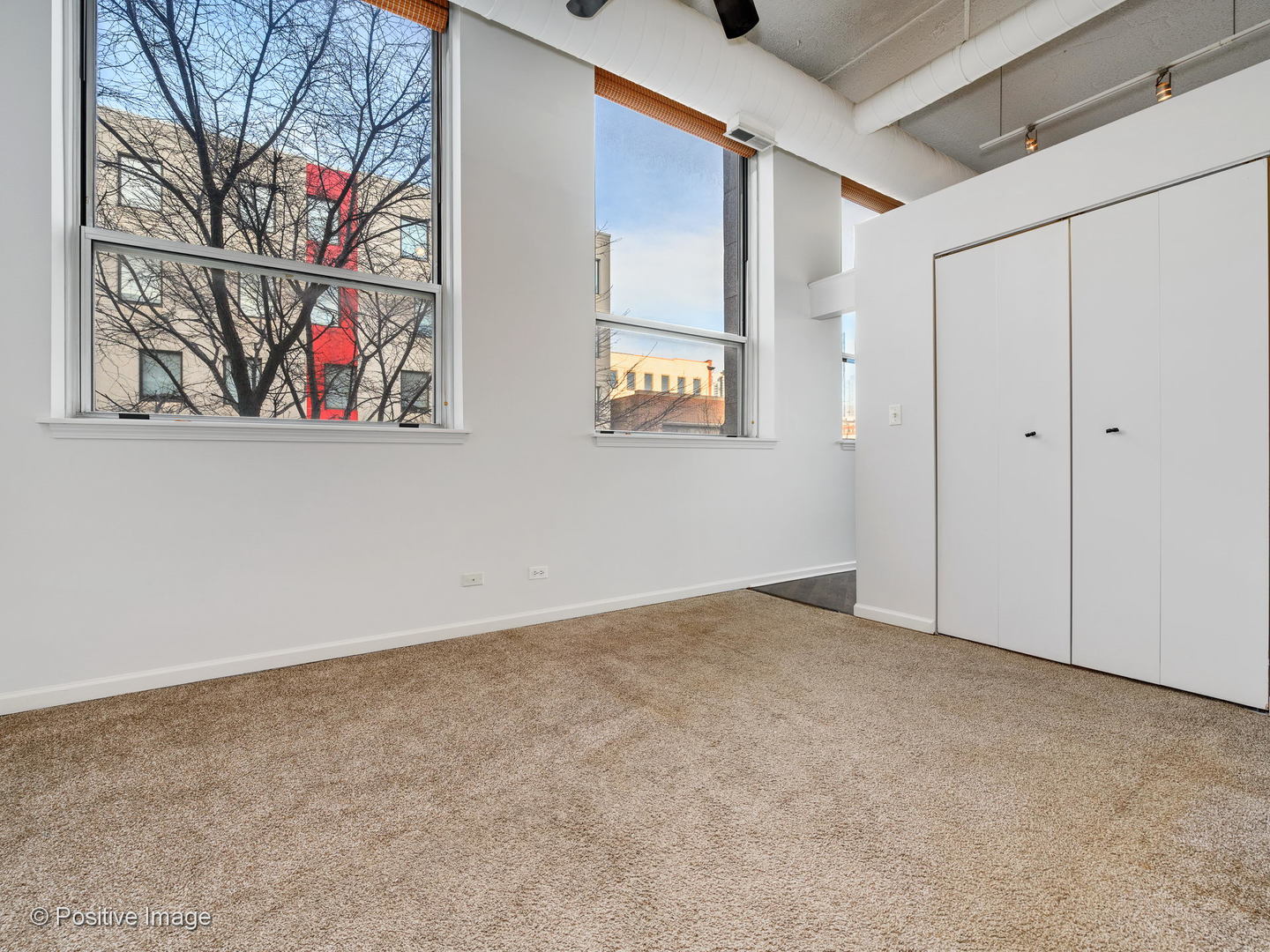 1019 West Jackson Boulevard, Unit 2B Chicago, IL 60607 - Photo 12 of 18 a view of an empty room with paintings on the wall