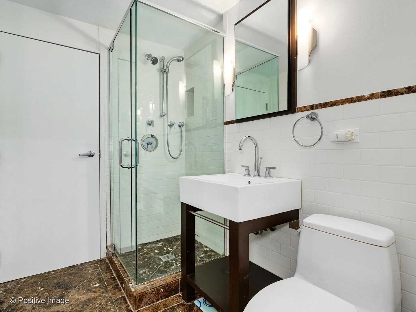 1019 West Jackson Boulevard, Unit 2B Chicago, IL 60607 - Photo 14 of 18 a bathroom with a sink toilet and shower