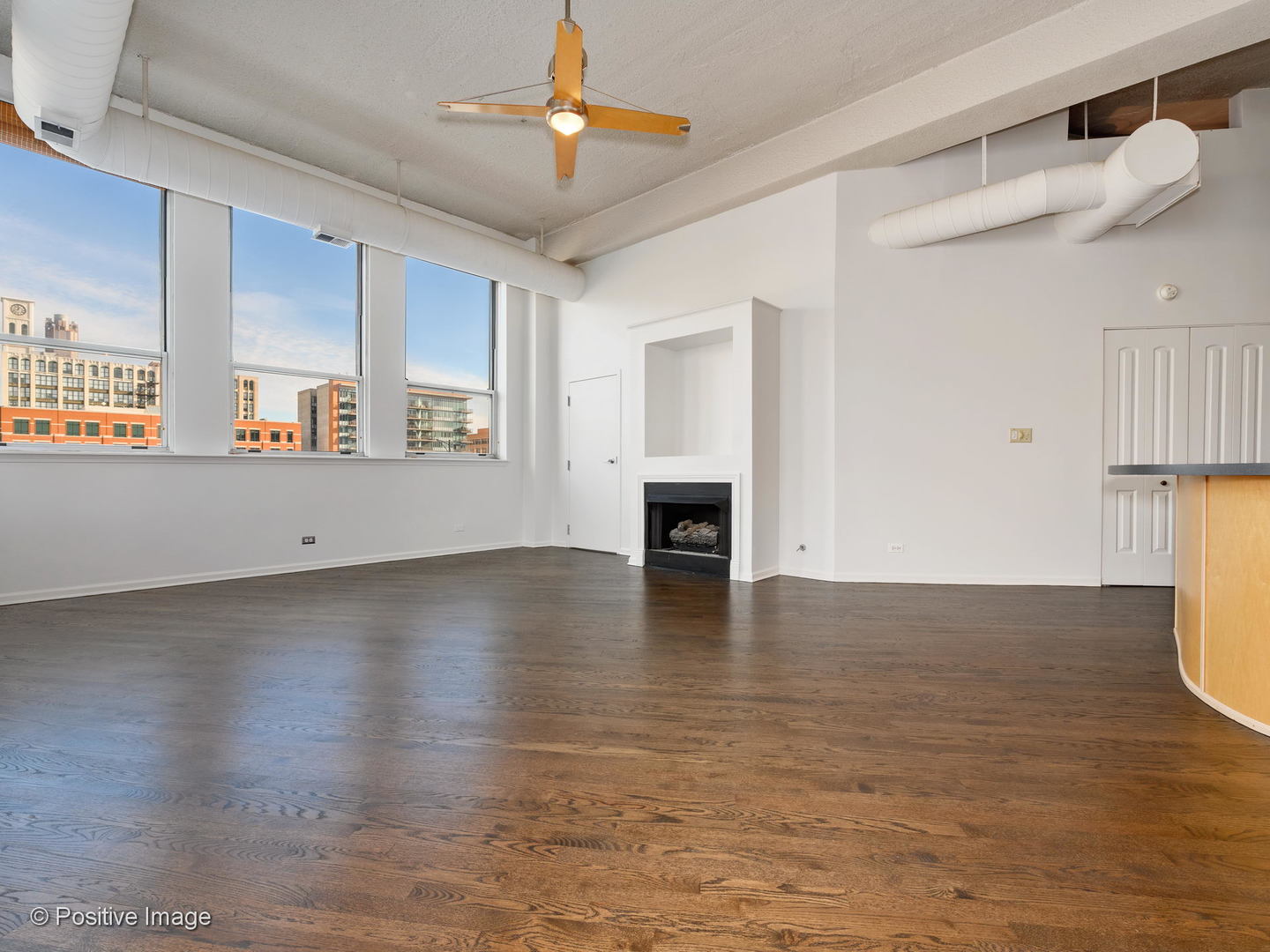 1019 West Jackson Boulevard, Unit 2B Chicago, IL 60607 - Photo 4 of 18 a view of an empty room with window and wooden floor