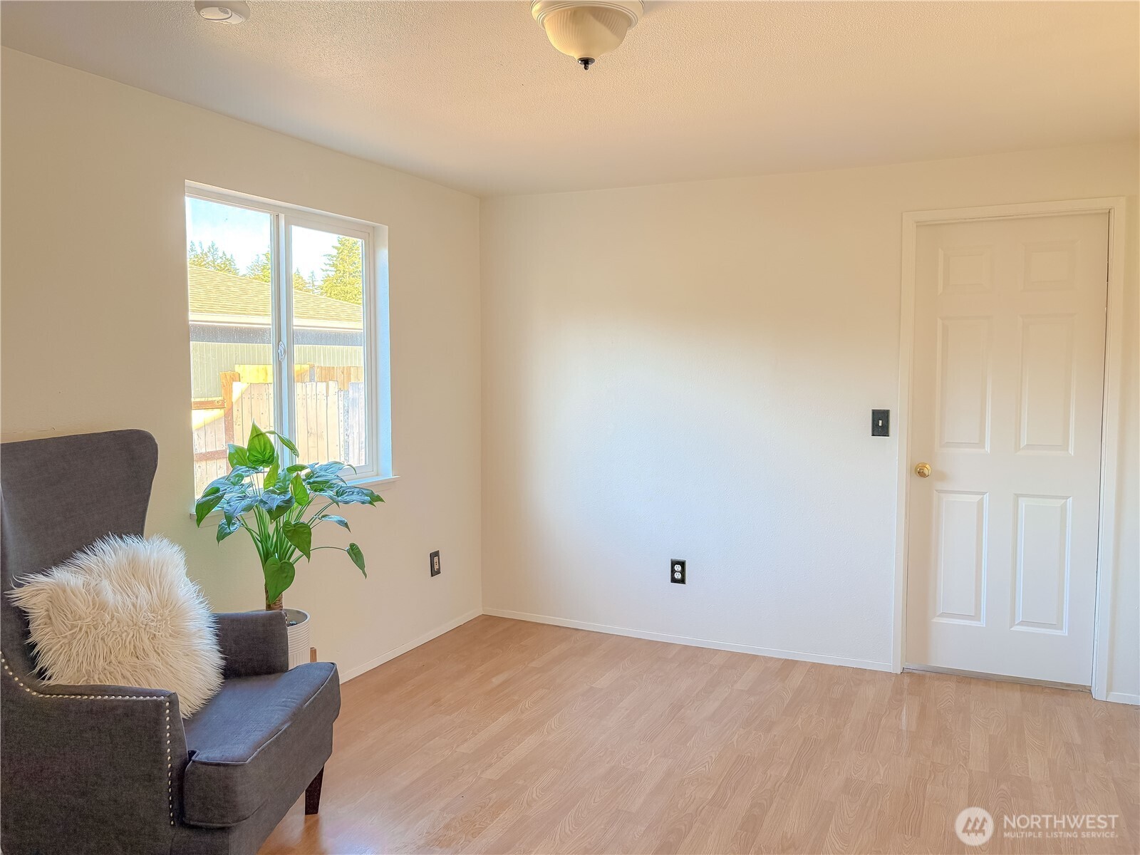 301 Seattle Street East Rainier, WA 98576 - Photo 16 of 18 a room with furniture and a potted plant
