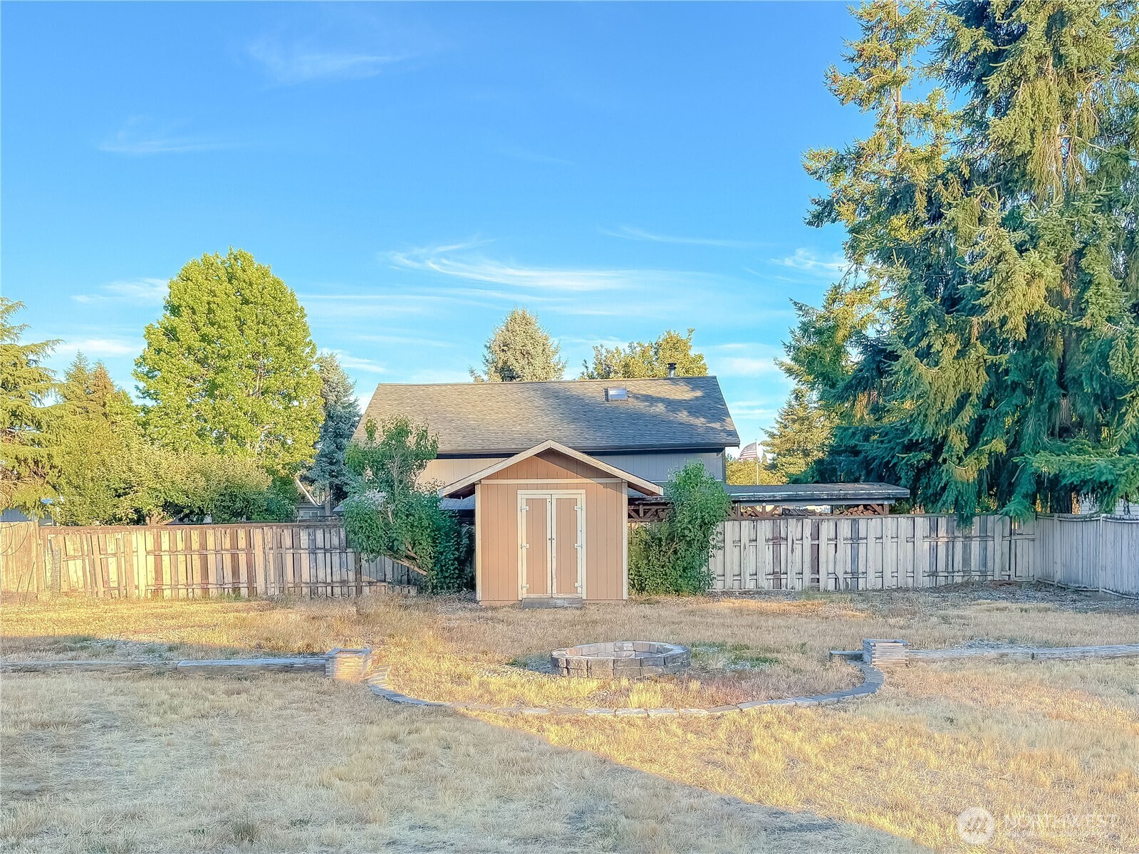 301 Seattle Street East Rainier, WA 98576 - Photo 17 of 18 a view of a house with a backyard and a garden