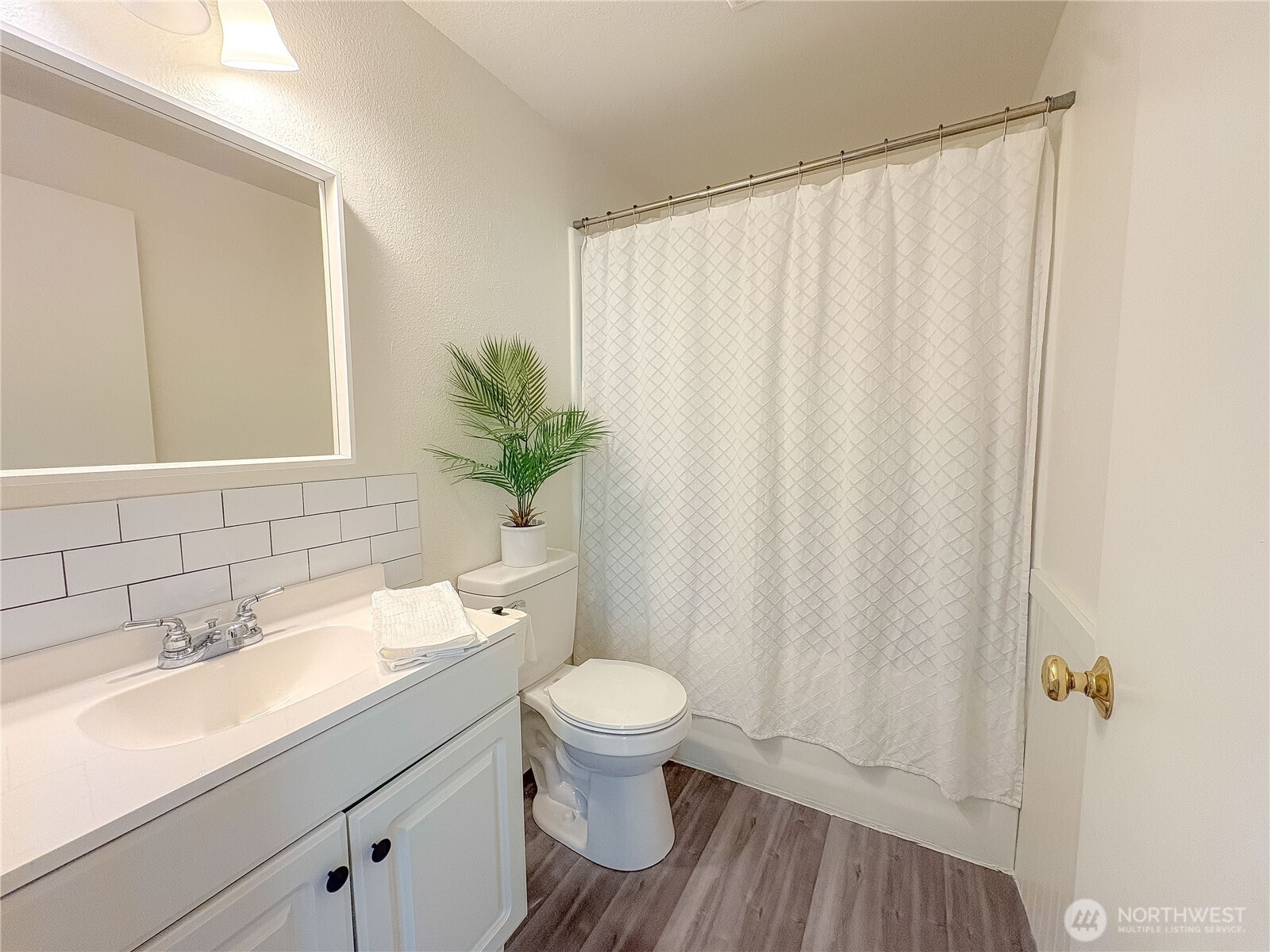 301 Seattle Street East Rainier, WA 98576 - Photo 9 of 18 a bathroom with a sink a toilet and shower