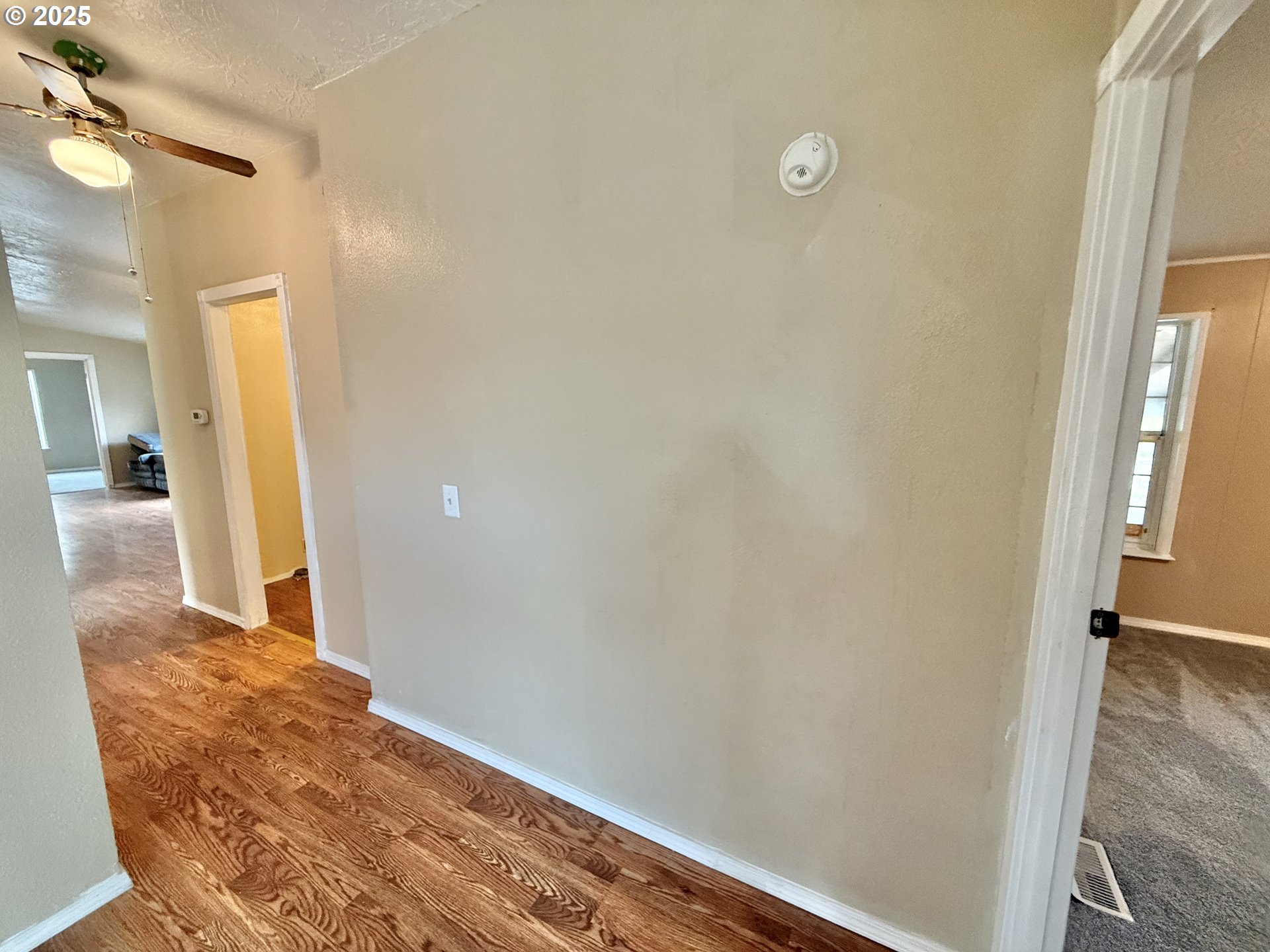 1282 3rd Street, Unit 37 Lafayette, OR 97127 - Photo 13 of 31 a view of a hallway with wooden floor and a bathroom