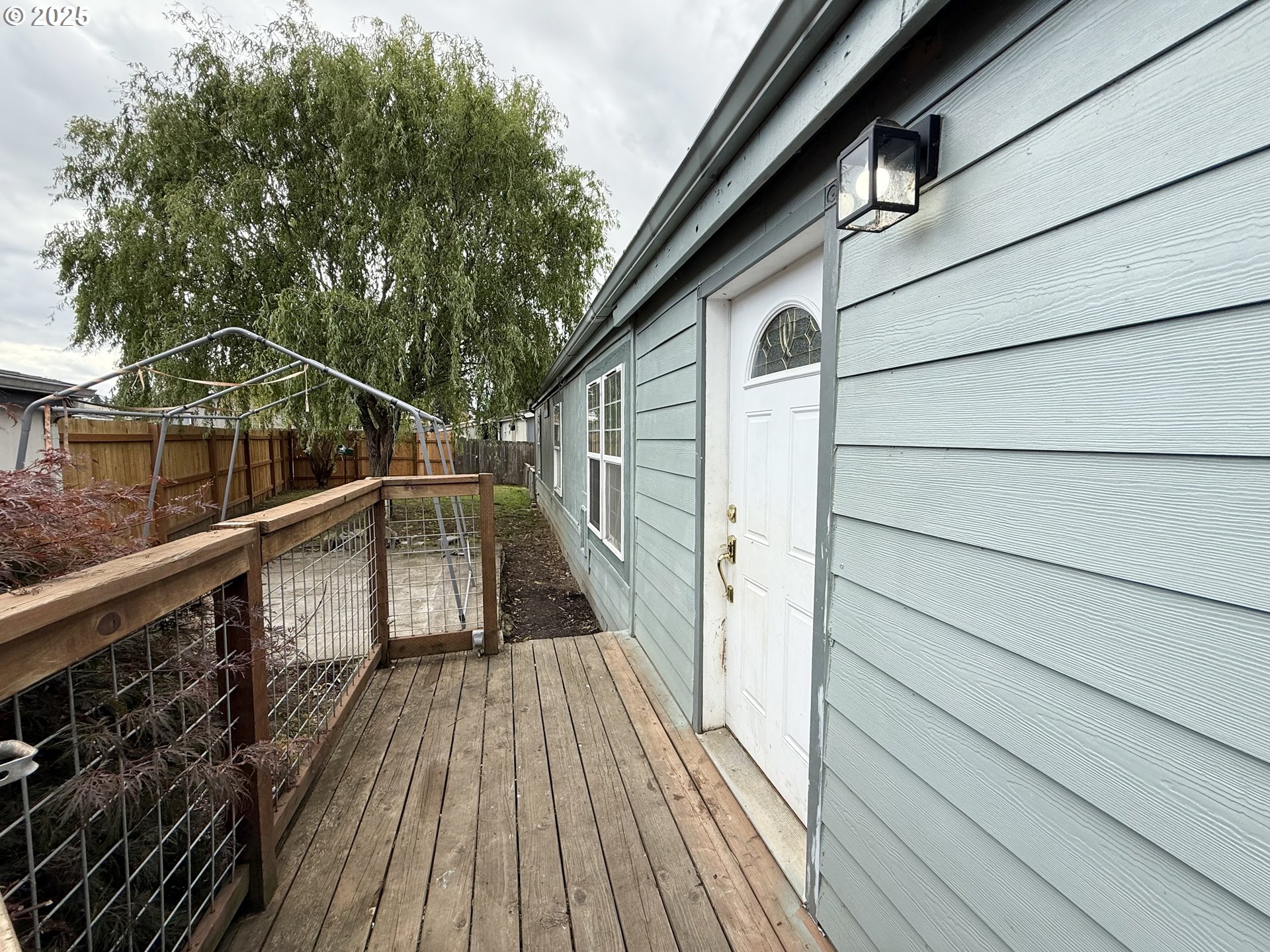 1282 3rd Street, Unit 37 Lafayette, OR 97127 - Photo 2 of 31 a view of balcony with wooden floor and fence and a potted plant