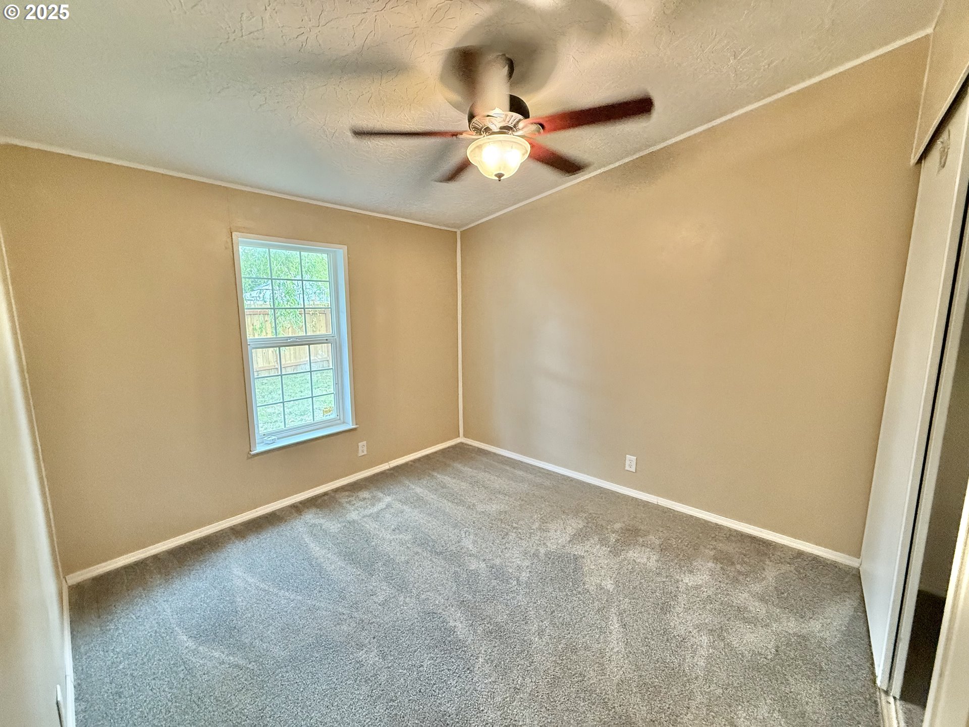 1282 3rd Street, Unit 37 Lafayette, OR 97127 - Photo 25 of 31 an empty room with windows and fan