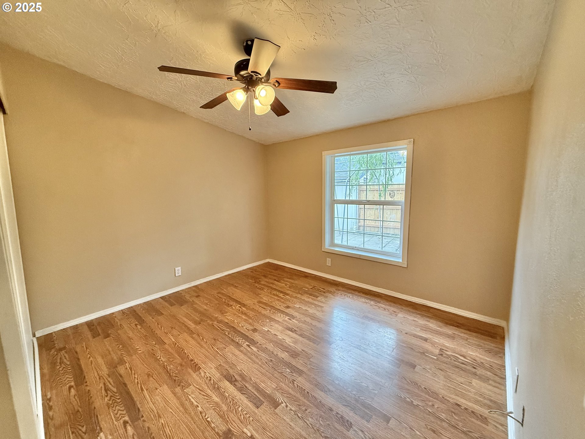 1282 3rd Street, Unit 37 Lafayette, OR 97127 - Photo 29 of 31 a view of an empty room with wooden floor and a window
