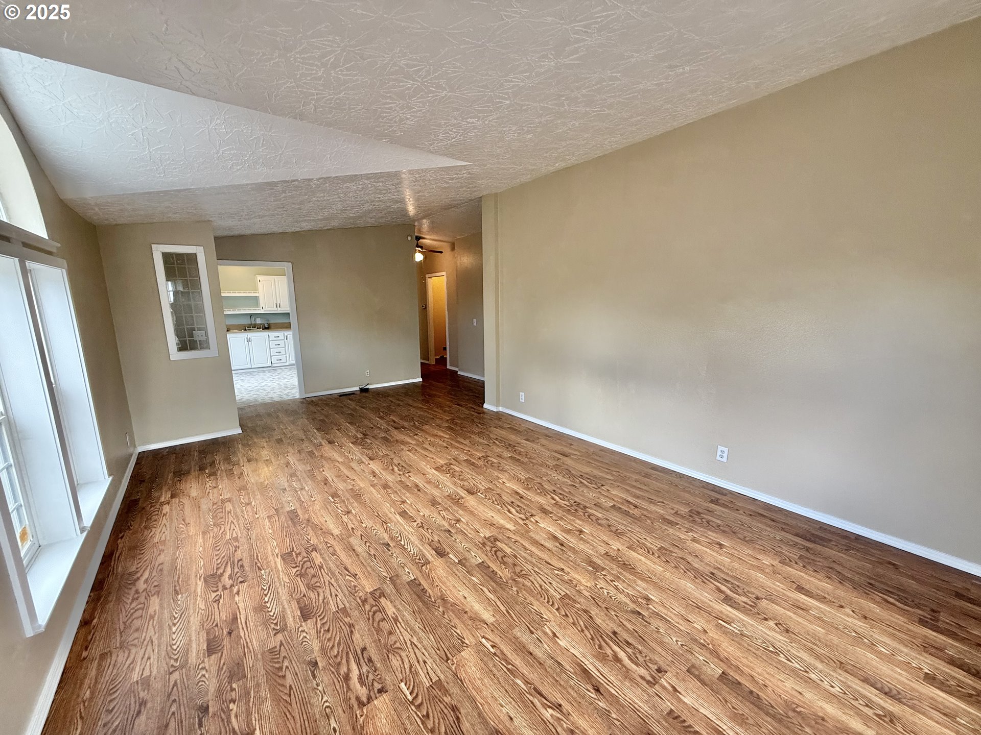 1282 3rd Street, Unit 37 Lafayette, OR 97127 - Photo 5 of 31 an empty room with wooden floor and windows
