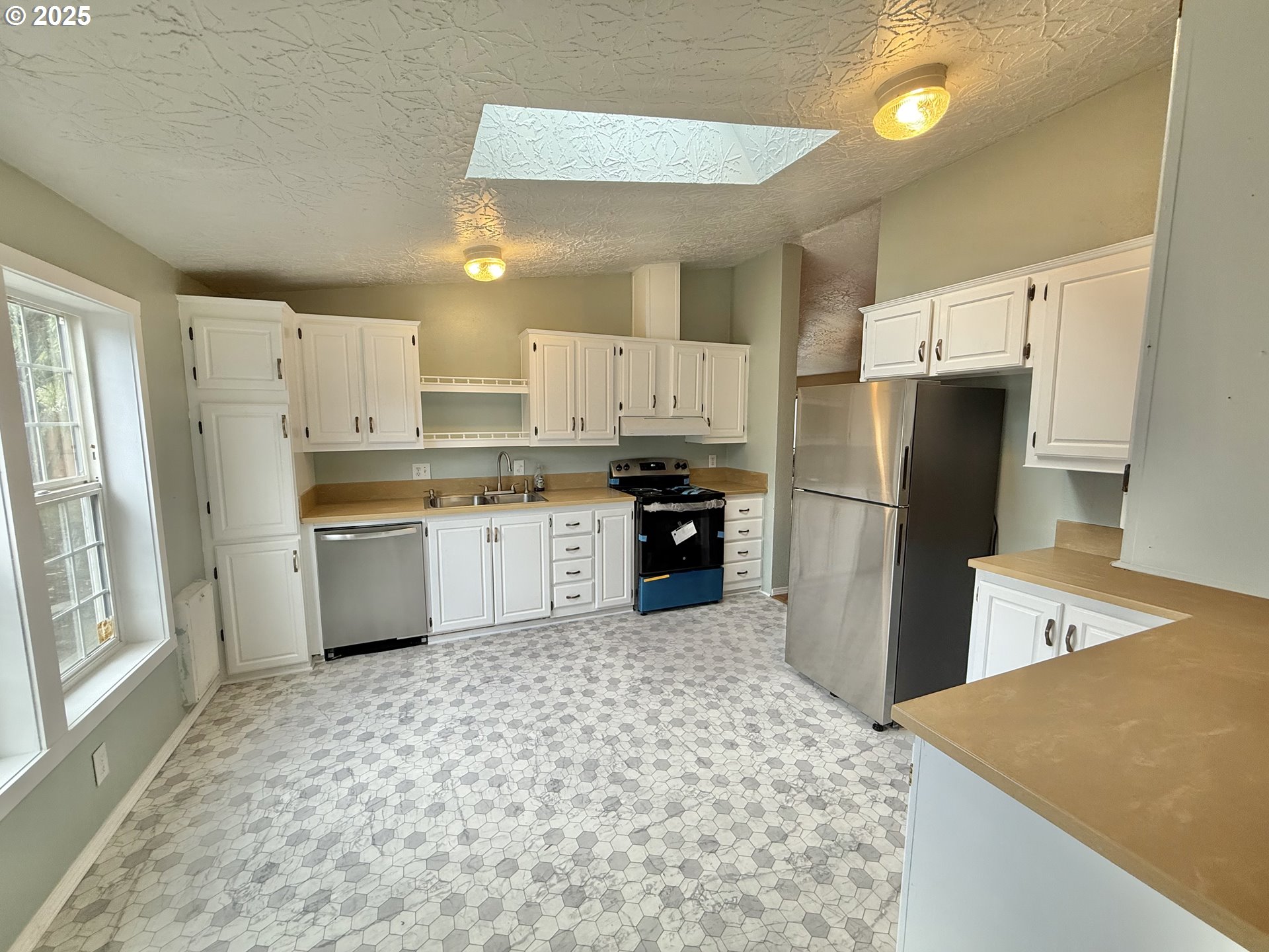 1282 3rd Street, Unit 37 Lafayette, OR 97127 - Photo 6 of 31 a kitchen with stainless steel appliances a refrigerator sink and cabinets