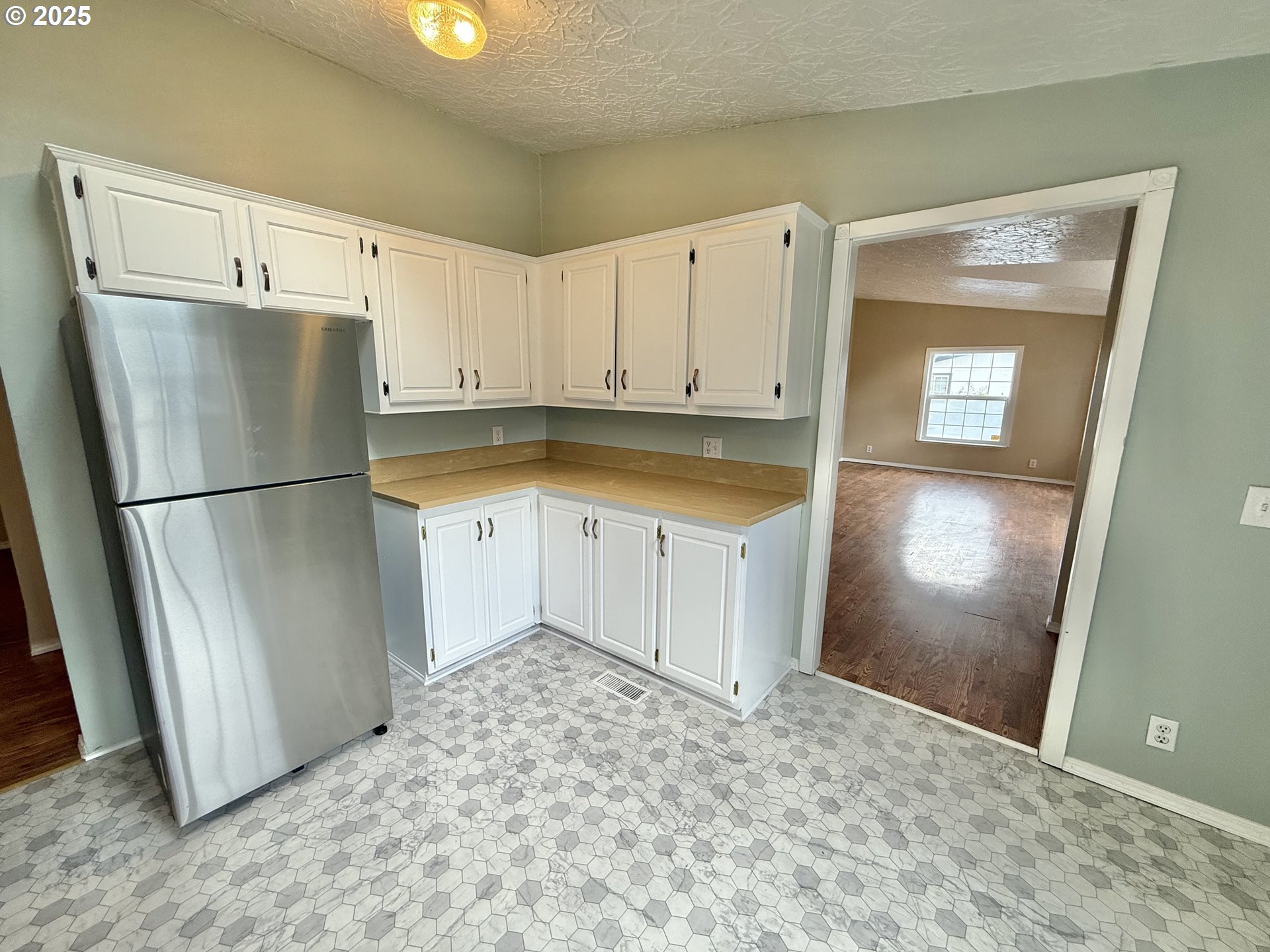 1282 3rd Street, Unit 37 Lafayette, OR 97127 - Photo 8 of 31 a view of a refrigerator in kitchen and wooden floor