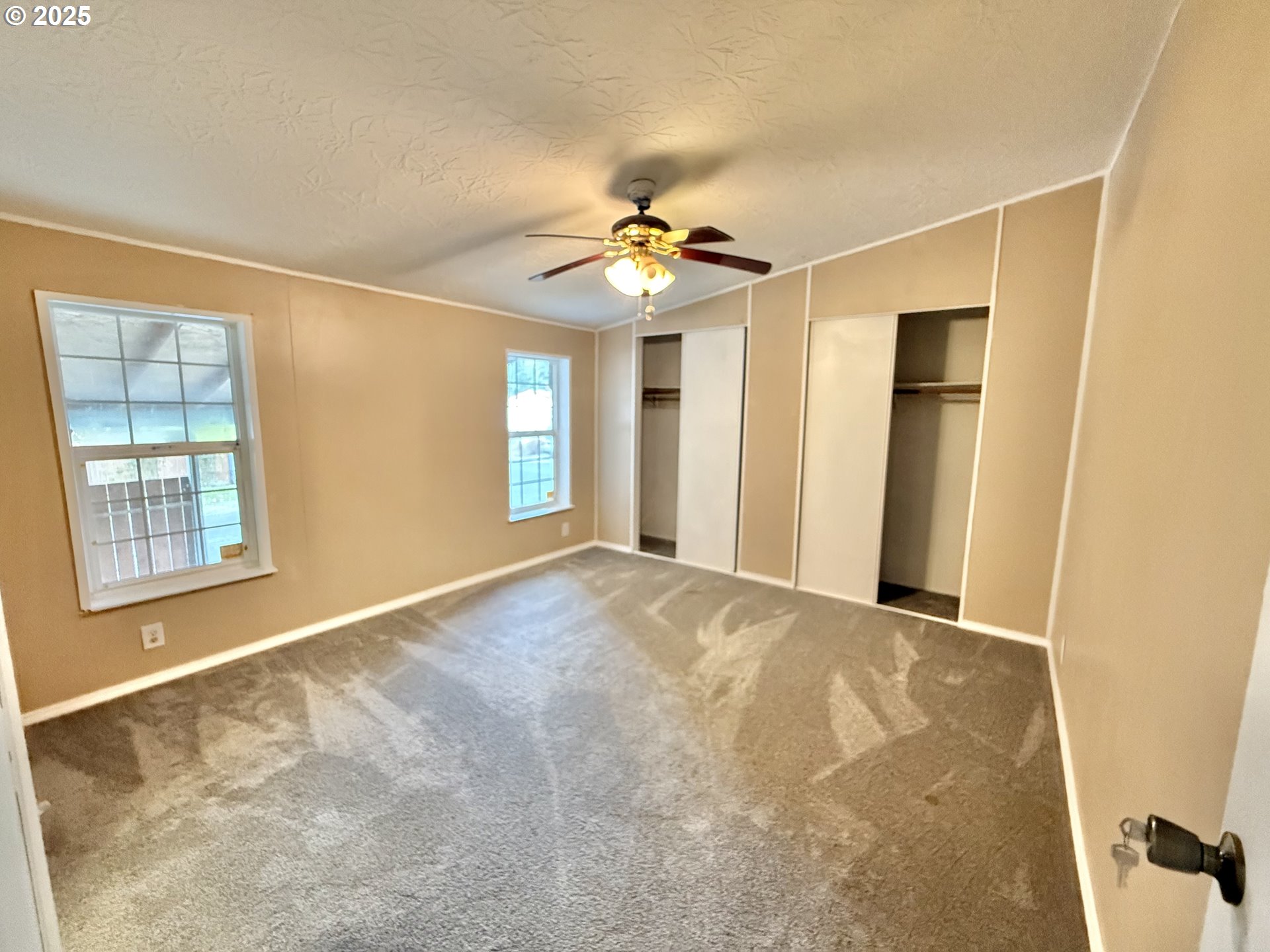 1282 3rd Street, Unit 37 Lafayette, OR 97127 - Photo 10 of 31 a view of an empty room with chandelier fan and fire place