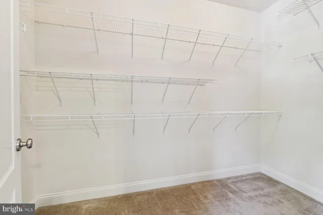 a spacious bathroom with a tub sink and mirror