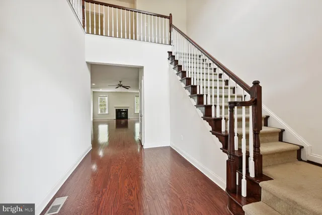 a view of staircase with wooden floor and a rug