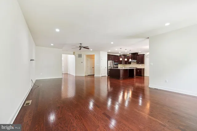 a view of a living room with kitchen and furniture