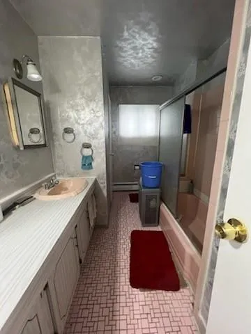 a bedroom with a bed and a lamp