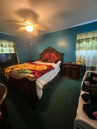 a bed sitting in a bedroom next to a window