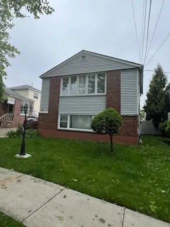 a view of house with a yard