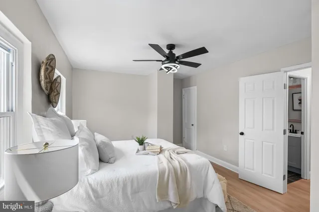 a bedroom with a large bed and a chandelier