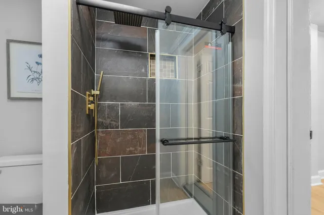 a bathroom with a glass shower door