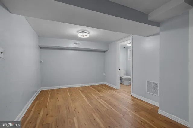 a view of room with empty room and wooden floor