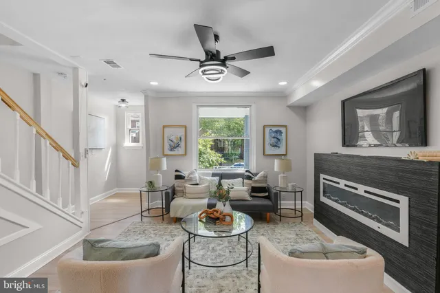 a living room with furniture a window and a fireplace