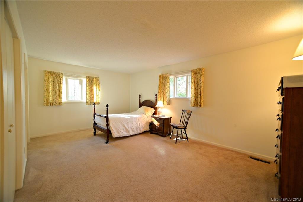 724 Laurel Ridge Road, Unit 23&24 Columbus, NC 28722 - Photo 15 of 25 a spacious bedroom with a bed and a window