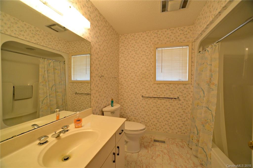 724 Laurel Ridge Road, Unit 23&24 Columbus, NC 28722 - Photo 18 of 25 a bathroom with a sink mirror and a shower