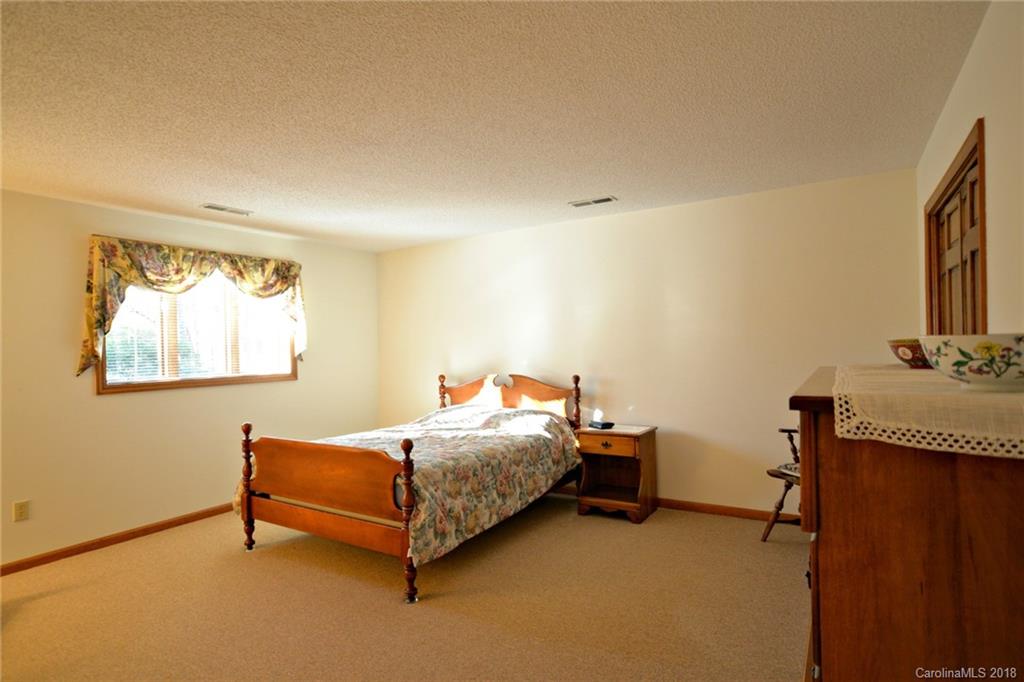 724 Laurel Ridge Road, Unit 23&24 Columbus, NC 28722 - Photo 20 of 25 a bedroom with a bed and a window