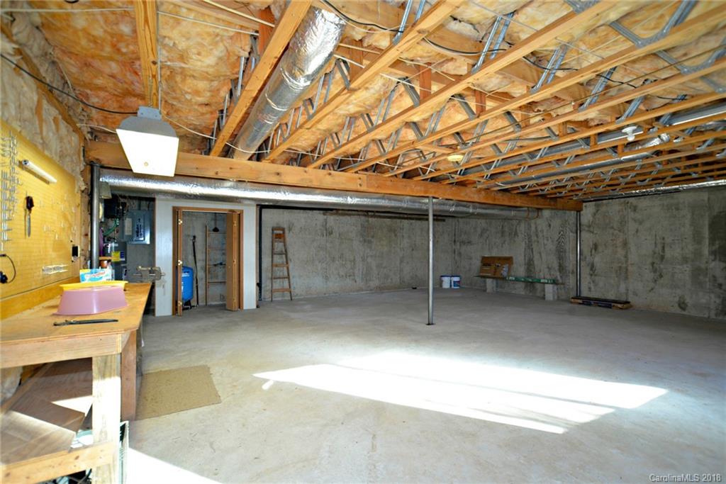 724 Laurel Ridge Road, Unit 23&24 Columbus, NC 28722 - Photo 22 of 25 a view of a porch with furniture and a garage