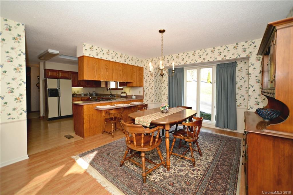 724 Laurel Ridge Road, Unit 23&24 Columbus, NC 28722 - Photo 10 of 25 a dining room with furniture a chandelier and wooden floor