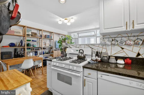 a kitchen with stainless steel appliances granite countertop a sink dishwasher and cabinets with wooden floor