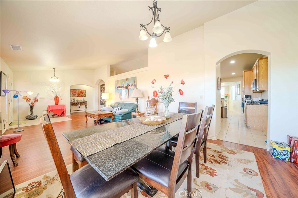 11522 Ponderosa Road Pinon Hills, CA 92372 - Photo 11 of 46 a view of a dining room with furniture and wooden floor