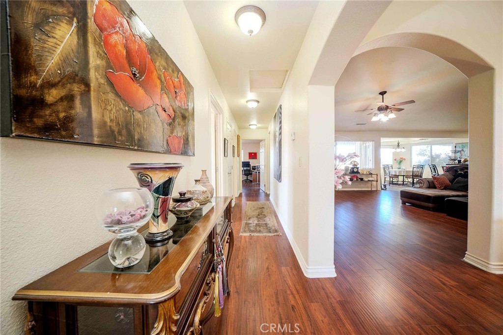 11522 Ponderosa Road Pinon Hills, CA 92372 - Photo 15 of 46 a view of a hallway with wooden floor and furniture