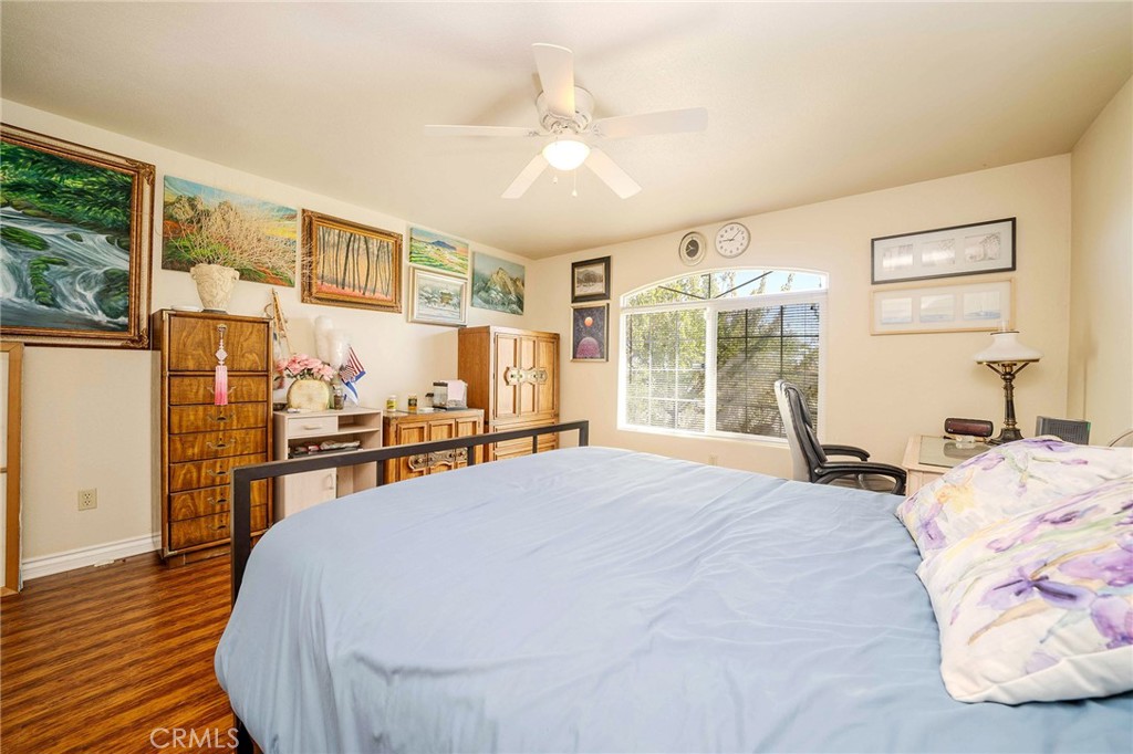 11522 Ponderosa Road Pinon Hills, CA 92372 - Photo 33 of 46 a bed room with a bed and a large window