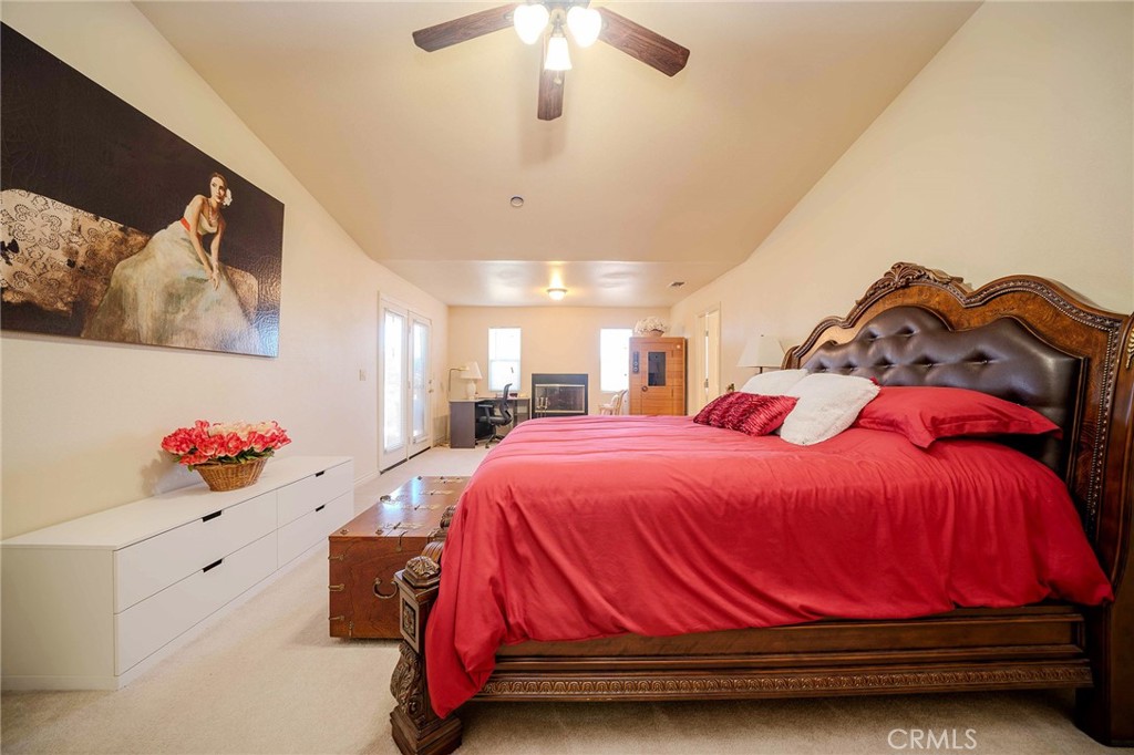 11522 Ponderosa Road Pinon Hills, CA 92372 - Photo 37 of 46 a bedroom with a bed and a chandelier
