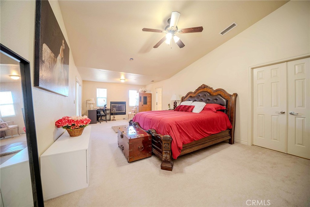 11522 Ponderosa Road Pinon Hills, CA 92372 - Photo 38 of 46 a bedroom with a bed and a chandelier