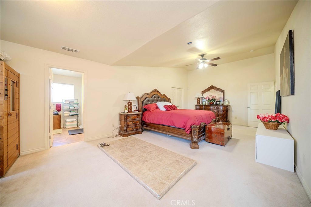 11522 Ponderosa Road Pinon Hills, CA 92372 - Photo 39 of 46 a bedroom with furniture and a chandelier