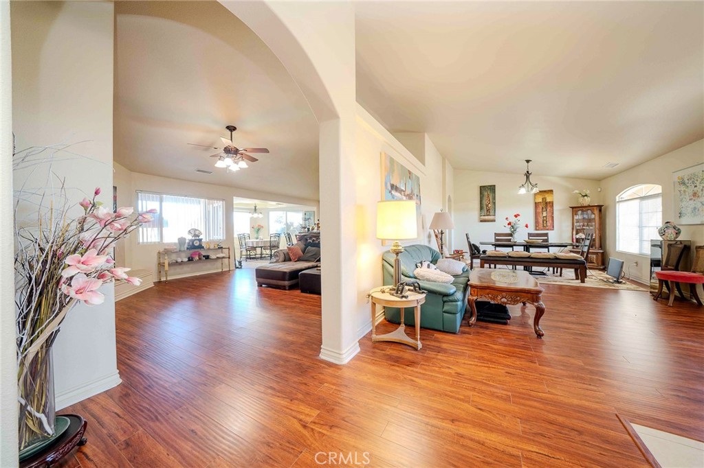 11522 Ponderosa Road Pinon Hills, CA 92372 - Photo 8 of 46 a living room with fireplace furniture and a wooden floor